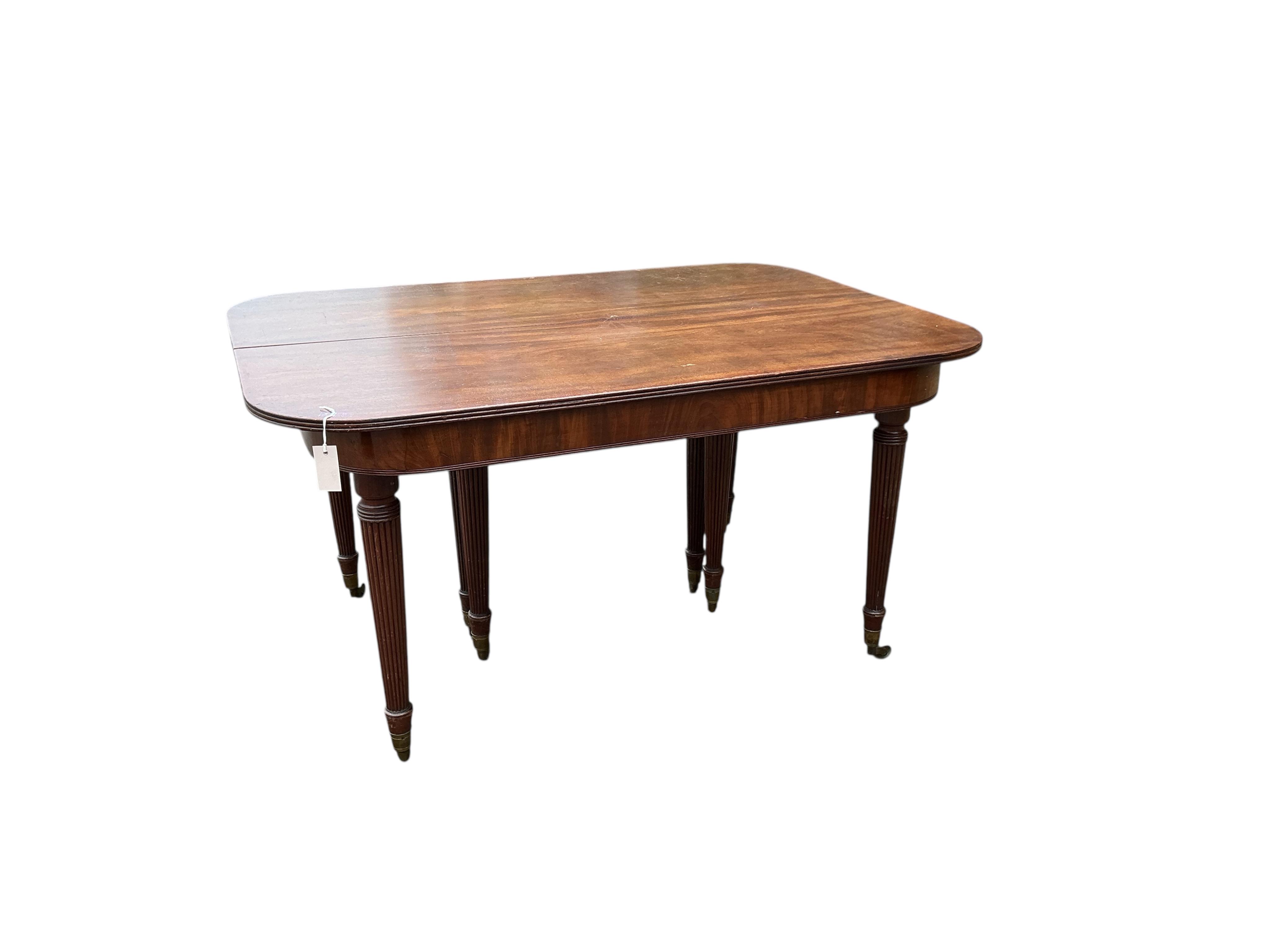 A Regency mahogany extending dining table, width 180cm extended, two spare leaves, depth 140cm, height 74cm